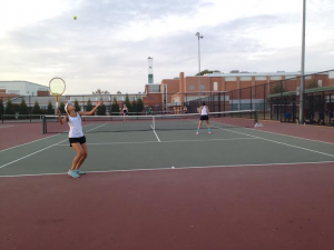 Senior and 2nd doubles player Liz Choi prepares to hit a serve in the third set with fellow senior and partner Raveesha Aurora.